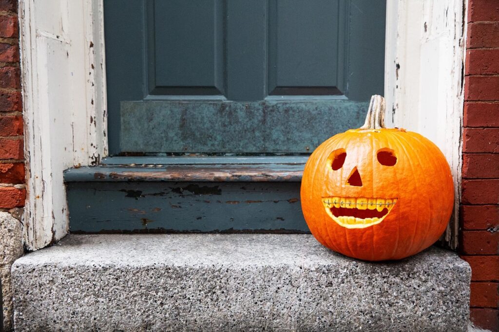 Pumpkin with carved braces smile celebrating National Orthodontic Health Month in Mansfield, TX