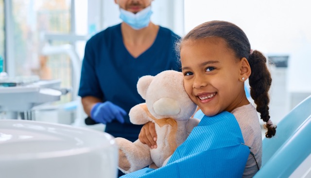 Child smiling at Rick Herrmann Orthodontics in Mansfield, TX during dental visit