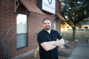 Dr. Jae Brimhall, orthodontist at Sunflower Orthodontics in Mansfield, TX, smiling and welcoming new patients